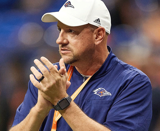 Coach Traylor clapping on sidelines